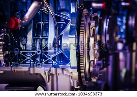 Closeup of motor car engine on assembly line of manufacturing industry being mass produced