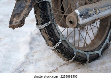 Close-up of a motorbike with snow chains - Shutterstock ID 2253891503
