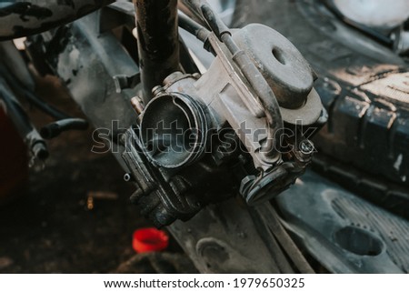 Close-up of the motorcycle carburetor in repair.