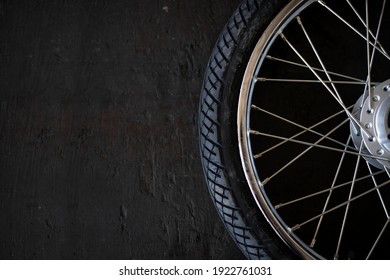 Closeup Motorcycle Tire On Old Black Wood Background. Top View. Flat Lay