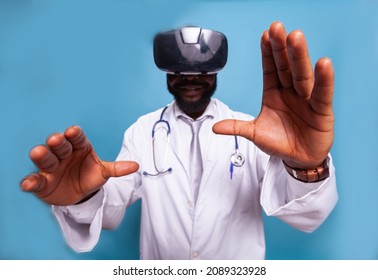 Closeup Of Moving Doctor Hands Using Virtual Reality Goggles For Medical Training. Medic In White Lab Coat With Stethoscope Using Vr Headset Modern Technology For Medical Investigation.