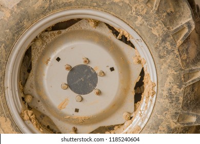 Closeup Of Muddy Tractor Tire And Wheel On Sunny Day.