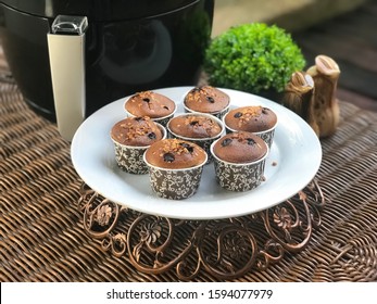 Closeup At Muffins Baked With Air Fryer In The White Plate On The Rattan Table.Ready To Eat.Outdoor,balcony,garden.