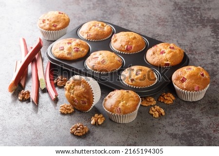 Close-up of muffins with walnuts and rhubarb in a baking dish on the table. horizontal
