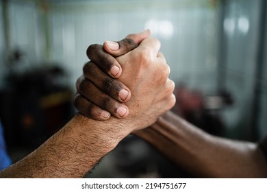 Close-up Of Multi-ethnic Man With Black And Caucasian Hands Holding Hands In The Concept Of Love, Unity And Anti-racism. Racial Diversity. Concept Of Success. Good Team Work