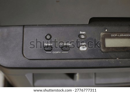 Close-up of a multifunction printer featuring digital controls and connectivity in an office