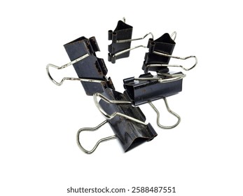 A close-up of multiple black binder clips attached together in a creative arrangement. The clips show signs of wear and rust, isolated on a white background.