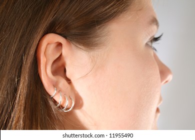 Close-up Of Multiple Ear Piercings On Young Girl.