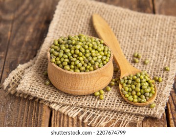 Close-up mung beans .Green mung beans in a wooden bowl on an old table