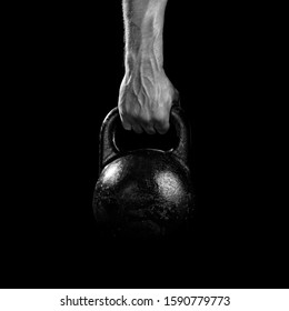 Close-up of a muscular hand holding a kettlebell. Athlete hand gripping a kettlebell. Close-up of a muscular hand holding a kettlebell. - Powered by Shutterstock