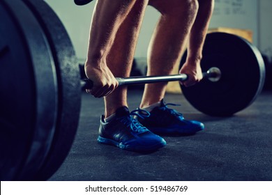 Closeup of muscular man doing deadlift exercise at gym - fitness, healthy lifestyle concept
