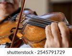 A Close-Up of a Musician Playing a Classic Violin in Soft Lighting.