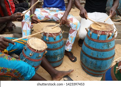 Close-up of a musician playing traditional drums on the beach in Accra, Ghana