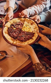 Close-up Of Muslim Friends Eating Traditional Turkish Pizza For Lunch On Ramadan.