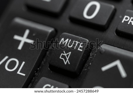 Close-up of a mute button on a remote control