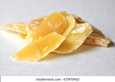 A Closeup Of Natural Blooming Beeswax Shavings Isolated On White.