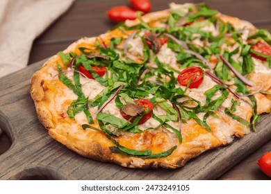 Close-up of a Neapolitan pizza or anchovy pizza with vegetables and anchovies on a wooden board. Rustic wooden board - Powered by Shutterstock