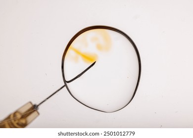 Close-up of a needle inserting into an egg cell under a microscope, representing in vitro fertilization (IVF) process.