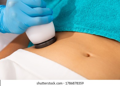 Closeup Of Needleless Mesotherapy Hardware Procedure To Reduce Body Fat And Tighten Skin On Female Belly In Aesthetic Clinic