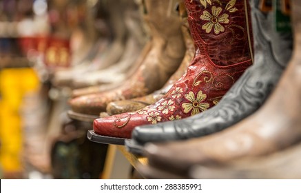 Close-up of new cowboy boots on shelf in a store