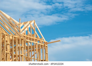 Closeup New Stick Built Home Under Construction Under Blue Sky In Humble, Texas, US. Framing Structure/wood Frame Of Wooden Houses/home. House Construction And Real Estate Concept Background. Panorama