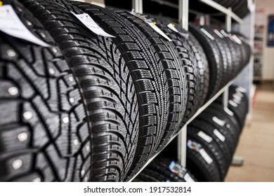 Close-up New Tires In The Auto Repair Service Center, Brand New Winter Tires With A Modern Tread Isolated. Selective Focus. Tire Stack Background.winter Season, No People