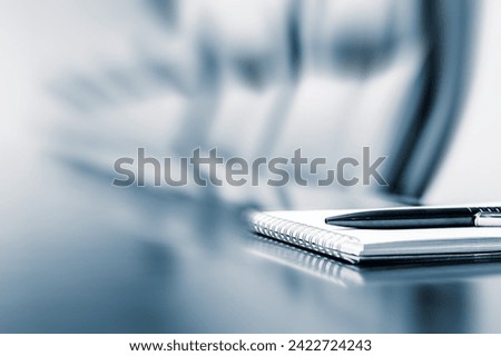 Closeup of notepad kept on table in empty room with motion blur effect