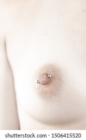 Close-Up of a Nude Breast with Nipple Piercing
