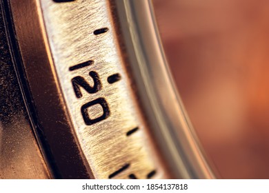 Close-up of the numbers on the outer ring of a watch. Selective focus, shallow depth of field.