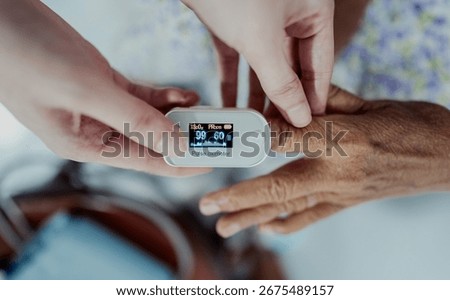 Close-up of nurse checking oxygen level with pulse oximeter on elderly woman’s finger. Medical technology, healthcare, diagnosis, and patient monitoring at home.