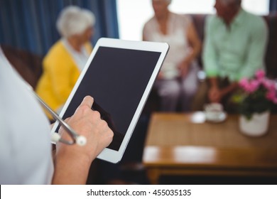 Close-up Of A Nurse Holding A Digital Tablet In A Retirement Home
