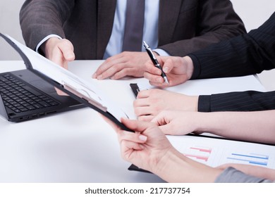 Close-up of office workers analyzing diaphragms on meeting - Shutterstock ID 217737754