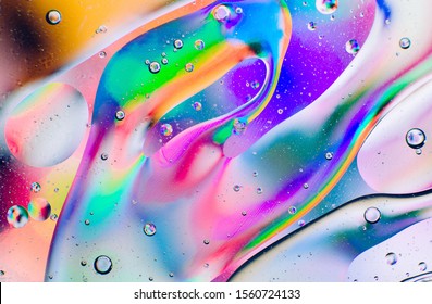 Closeup oil drops motion water surface   Colorful abstract macro background oil drops water surface and air bubbles inside