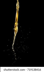 Close-up Of Oil Or Liquid Pouring, Isolated On Black Background