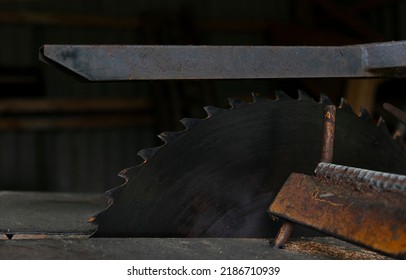 Closeup of an old circular table saw in workshop.