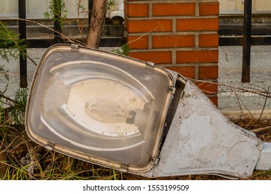 Closeup Of Old Dismantled, Broken Streetlight Removed From Lamppost And Laying On Ground.