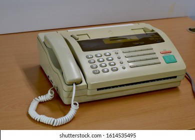 Closeup Of Old Fax Machines Are Not Used Placed On A Wooden Table. Concept Office Equipment.