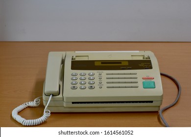 Closeup Of Old Fax Machines Are Not Used Placed On A Wooden Table. Concept Office Equipment.