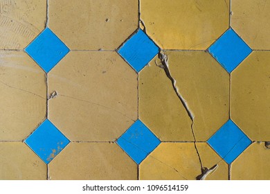 Close-up of an old floor tile with a two-tone pattern. Chapped floor tiles - Powered by Shutterstock