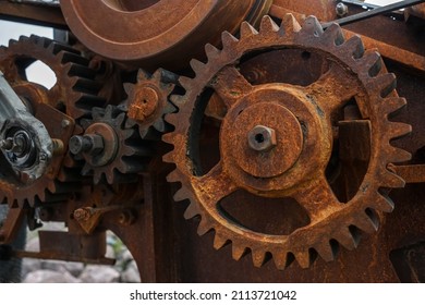 Close-up Of Old Industrial Rusty Gear. Mechanical  Background. Old Mechanical Cog Wheel - Close Up. Aged Cogwheels.  Drive Belt. Belting. 