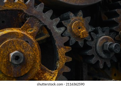 Close-up Of Old Industrial Rusty Gear. Mechanical  Background. Old Mechanical Cog Wheel - Close Up. Aged Cogwheels