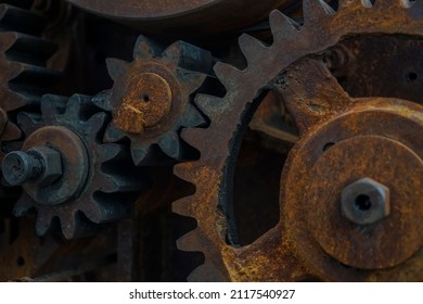 Close-up Of Old Industrial Rusty Gear. Mechanical  Background. Old Mechanical Cog Wheel - Close Up. Aged Cogwheels