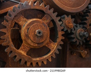 Close-up Of Old Industrial Rusty Gear. Mechanical  Background. Old Mechanical Cog Wheel - Close Up. Aged Cogwheels.  Drive Belt. Belting. 