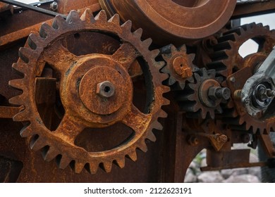 Close-up Of Old Industrial Rusty Gear. Mechanical  Background. Old Mechanical Cog Wheel - Close Up. Aged Cogwheels.  Drive Belt. Belting. 