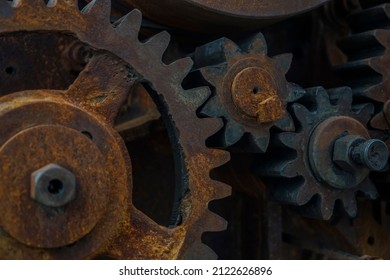 Close-up Of Old Industrial Rusty Gear. Mechanical  Background. Old Mechanical Cog Wheel - Close Up. Aged Cogwheels