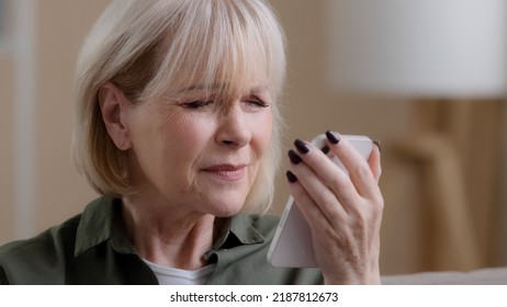 Close-up old lady mature aged female grandmother Caucasian retired woman looking at phone screen vision problems poor eyesight trying to read news disease eyes damage needs glasses or laser - Powered by Shutterstock