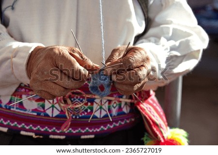 Similar – Image, Stock Photo A man in knitted sweater and light pants helps a small child with red cap to explore on the beach