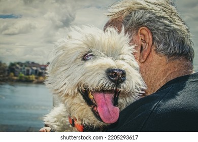 Close-up Of Old Man Hugging Old Dog With River Blurred In Background-West Highland White Terrier