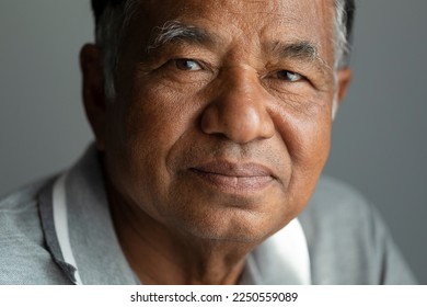 Close-up, old man's face, elderly Asian man thinking and looking at camera in studio. - Powered by Shutterstock