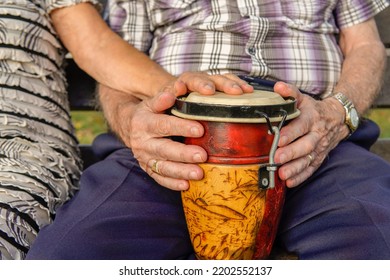 Close-up Of Old Matrimony Playing An African Drum. Old Age Physical Activity